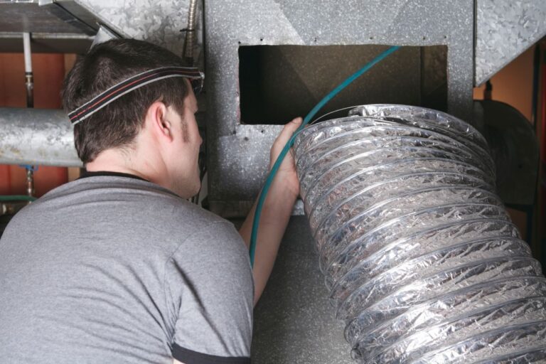 A ventilation cleaner man at work with tool