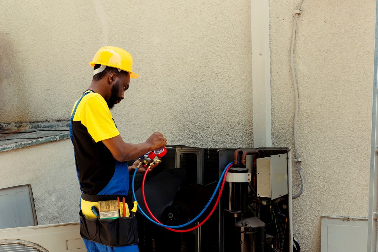 Competent mechanic employed by customer after complaints about frost on air conditioner evaporator coils. Expert repairman using manifold indicators to detect hvac system optimum fixing ... See More