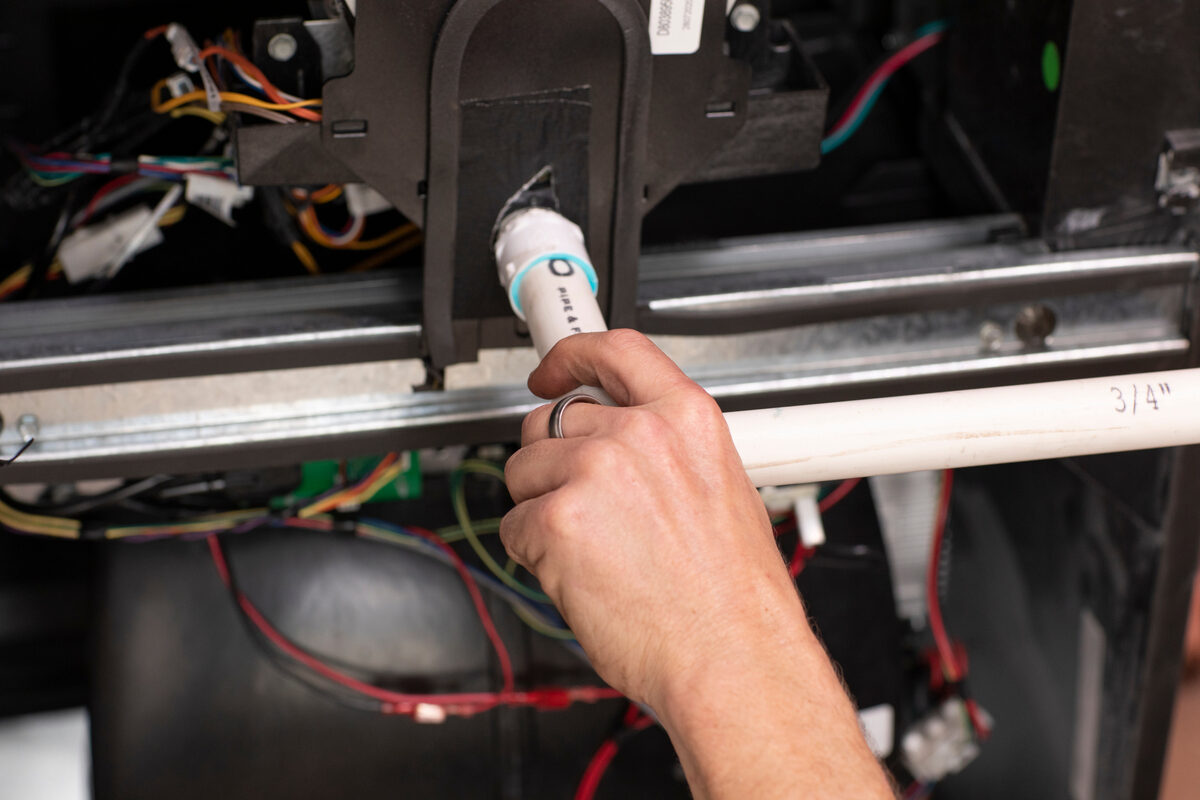 HVAC technician inspecting equipment inside a mechanical space
